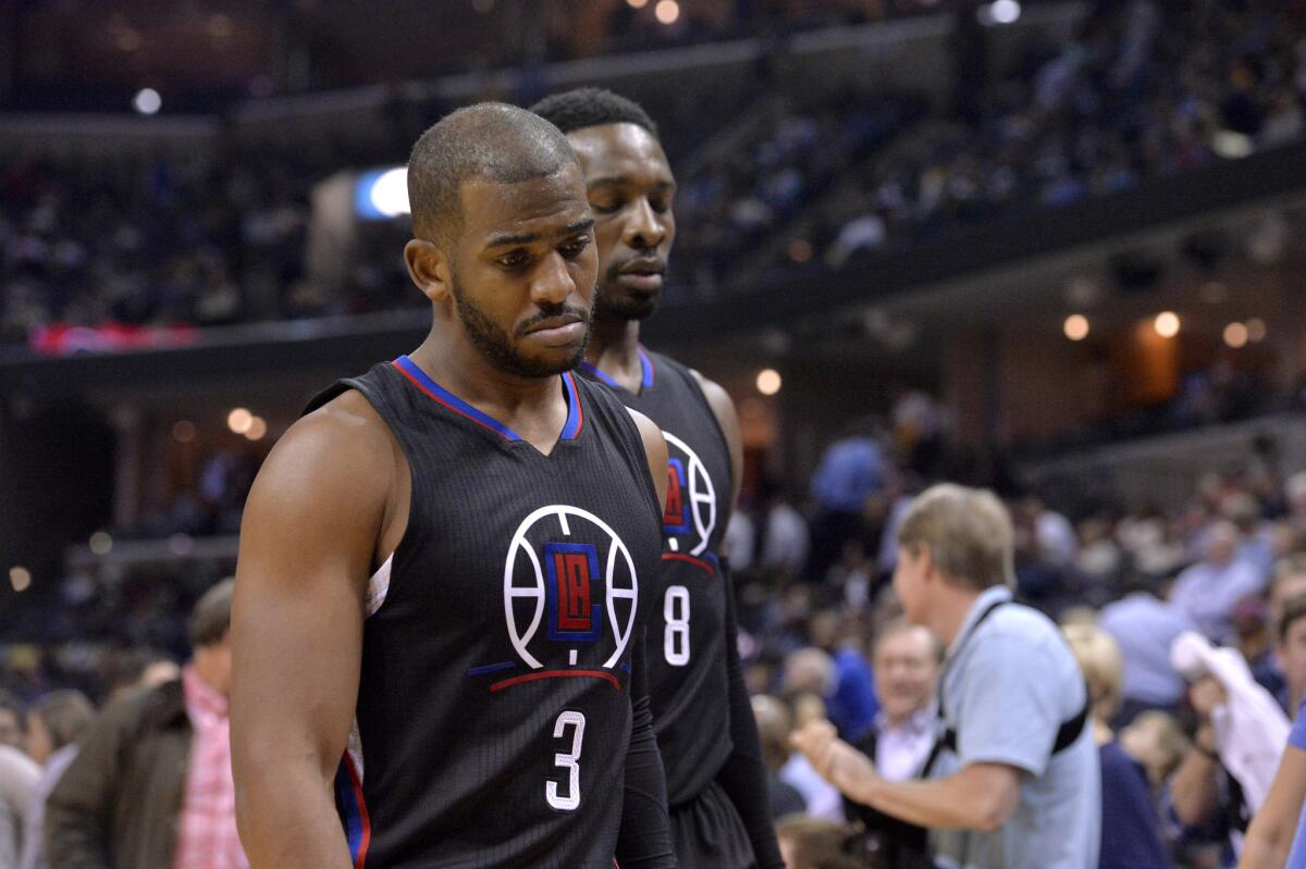 Clippers guard Chris Paul (3) and forward Jeff Green (8) walk off the court after the first half of a game against the Grizzlies.