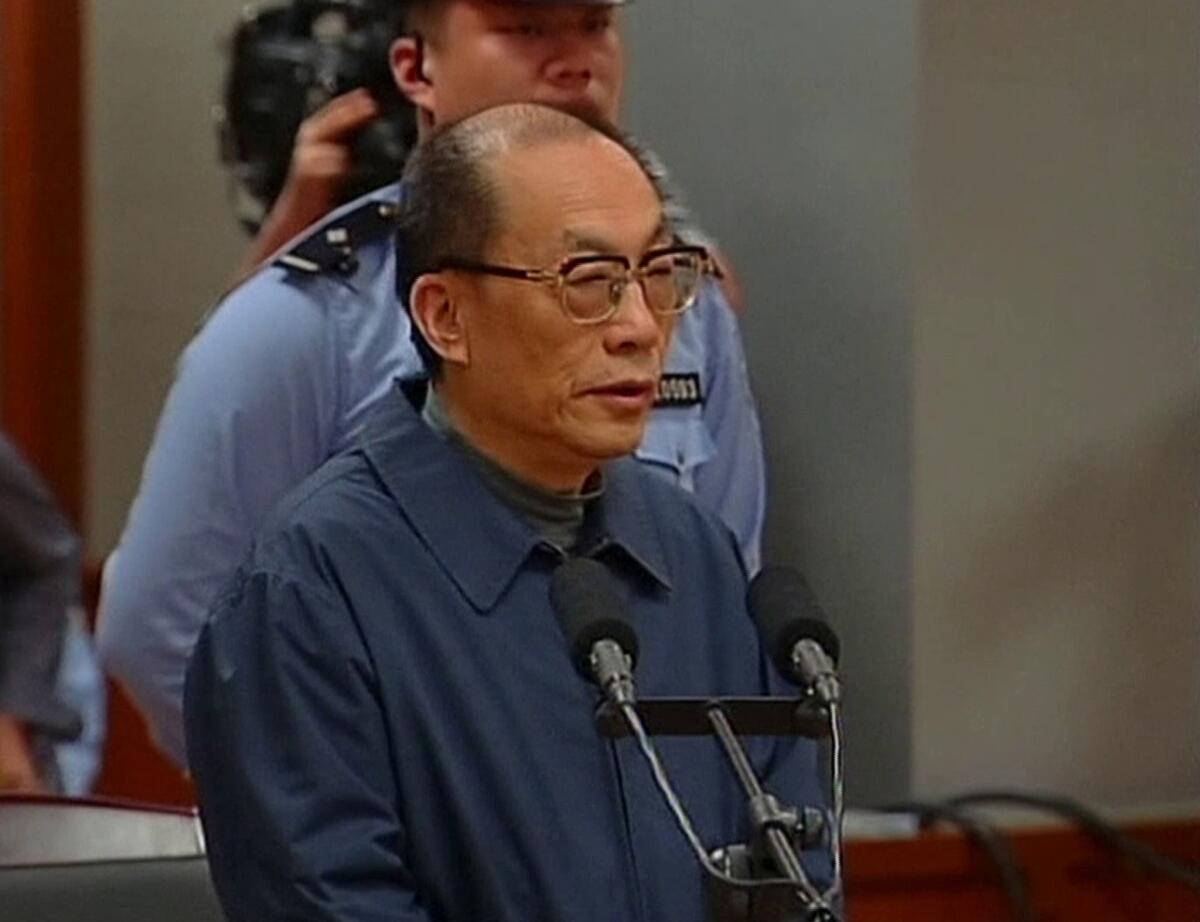 Former Chinese Railways Minister Liu Zhijun speaks during court proceedings in his corruption and bribery case in Beijing.