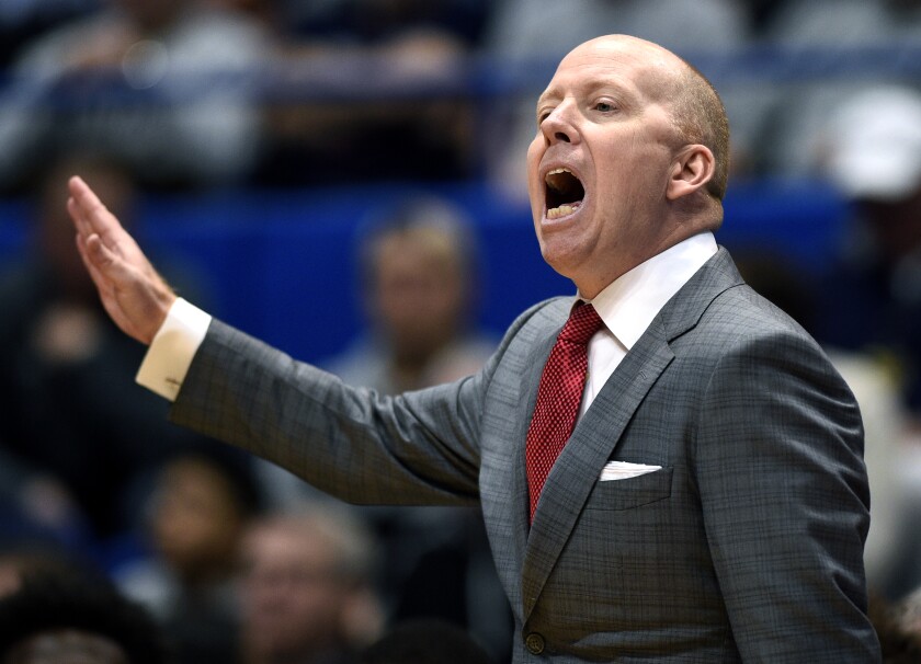 Mick Cronin shouts instructions to his players during a game.