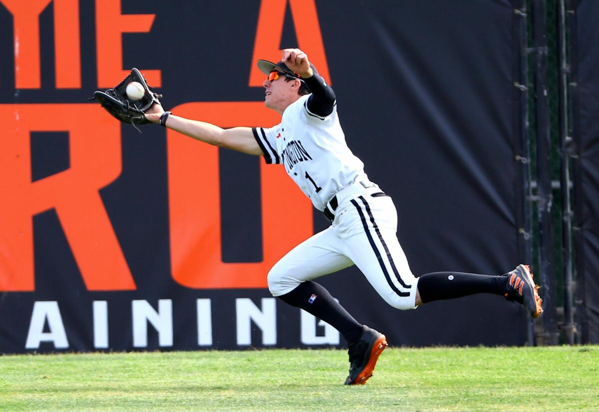 Huntington Beach right fielder Matt Haidl making a lunging catch 