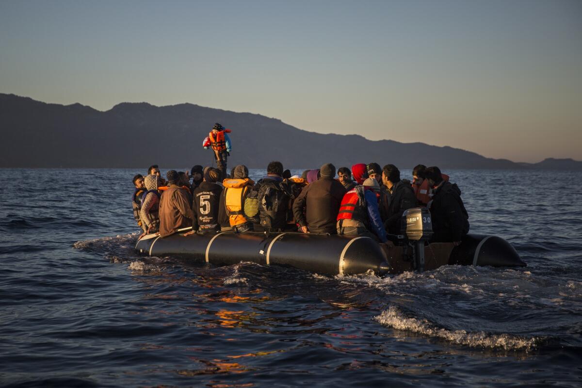 Refugees and migrants approach the Greek island of Lesbos after crossing the Aegean sea from the Turkish coast on Dec. 24.