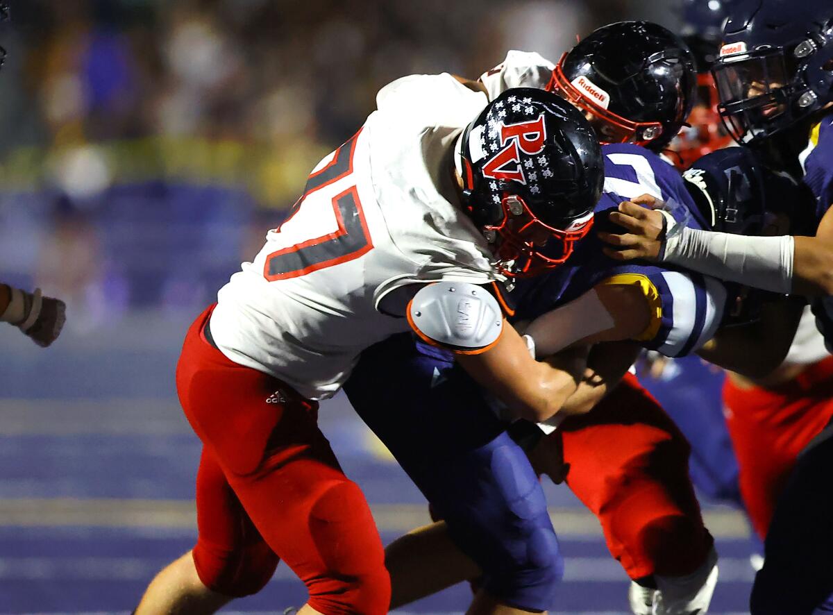 Carson Moore of Palos Verdes drops a Santa Monica ballcarrier.