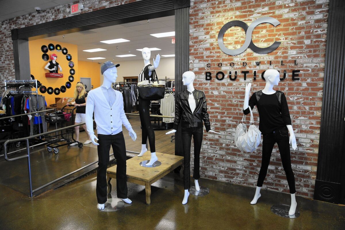 The O.C. Goodwill Boutique in Huntington Beach features wooden floors and artfully arranged clothing displays.