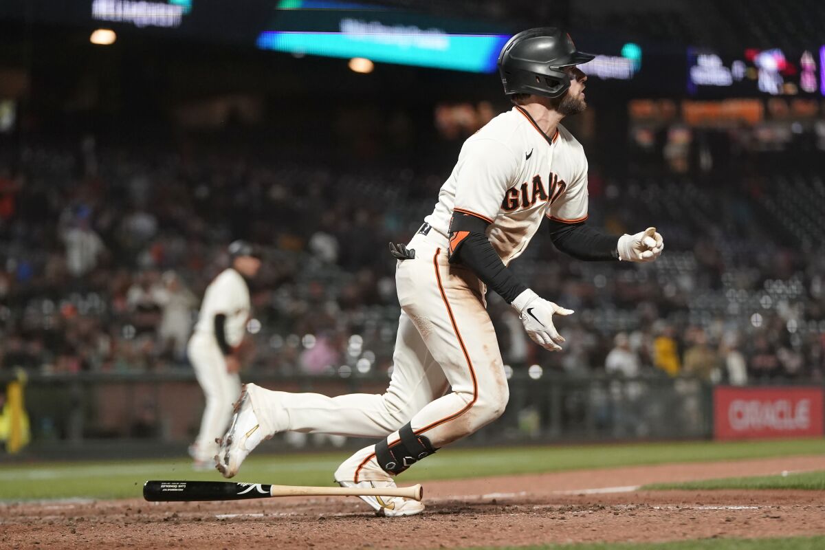 San Francisco Giants' Luis Gonzalez watches his base hit during the 10th inning of a baseball game against the Colorado Rockies in San Francisco, Wednesday, June 8, 2022. The Giants' Donovan Walton scored on the play after an error by Rockies' Charlie Blackmon. (AP Photo/Jeff Chiu)