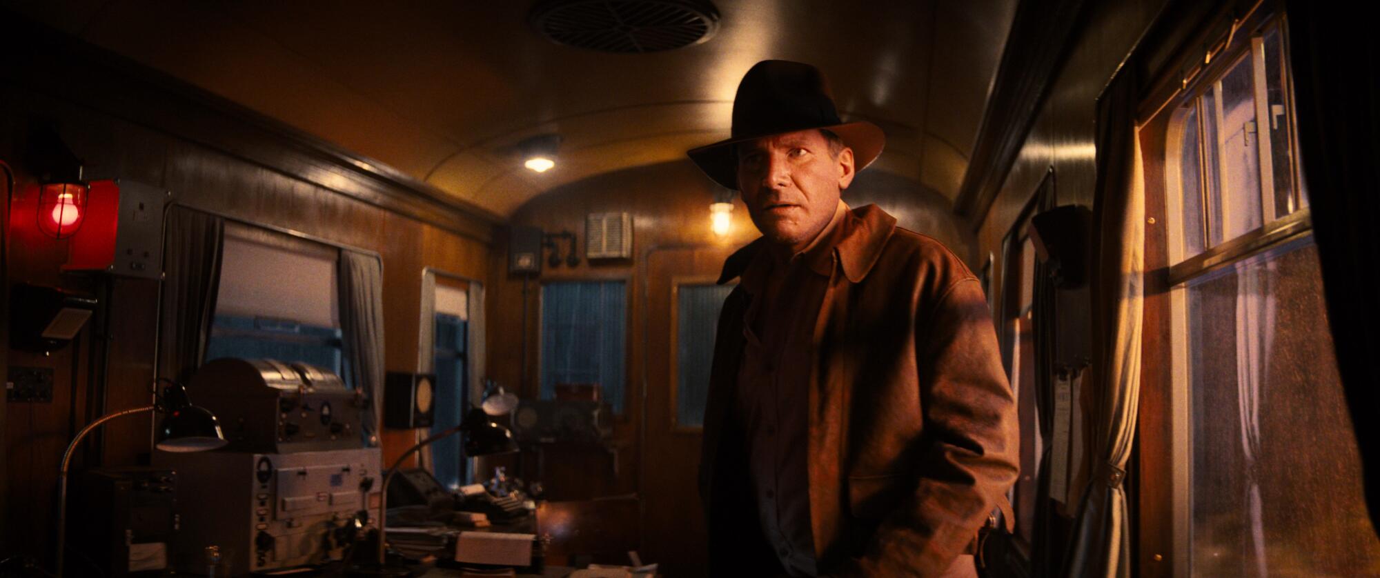 Harrison Ford returns as Indiana Jones in a train car.
