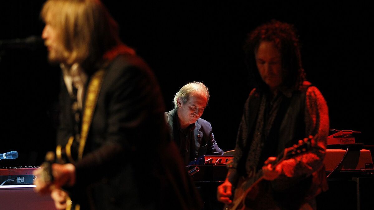 Tom Petty, left, leading the Heartbreakers, including keyboardist Benmont Tench and guitarist Mike Campbell, at a 2012 benefit concert for radio station KCSN at Cal State Northridge.