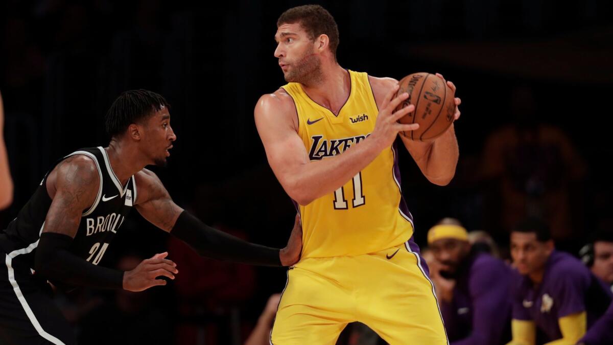 Lakers center Brook Lopez is defended by Nets forward Rondae Hollis-Jefferson during Friday's game.