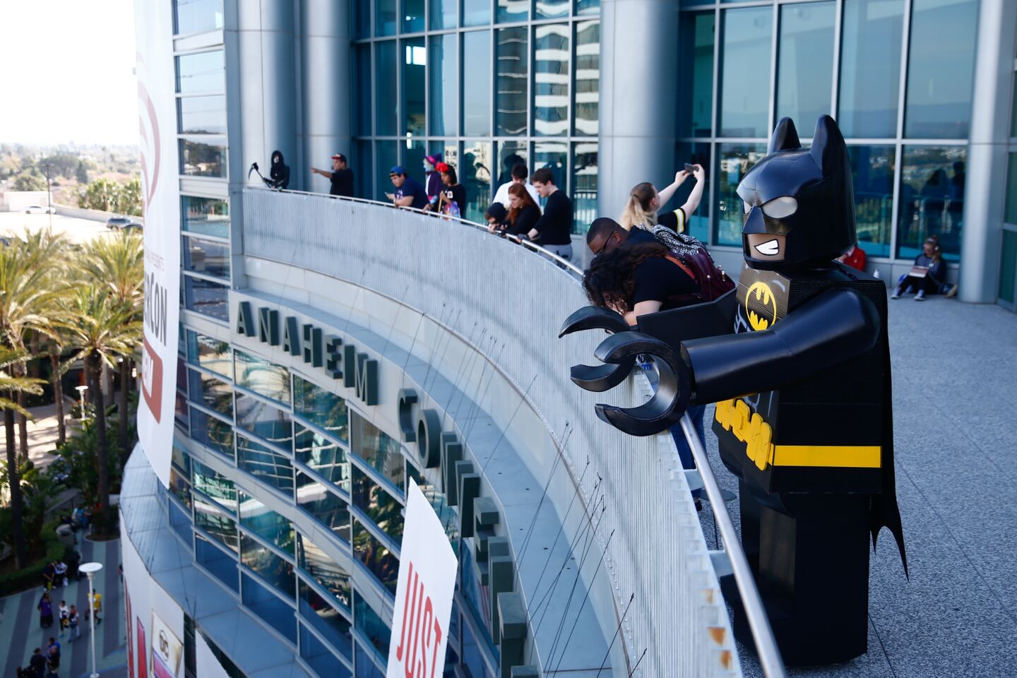 John Lopez, 53, of Palmdale, cosplays as Lego Batman while checking out the scene from a balcony at the Anaheim Convention Center.