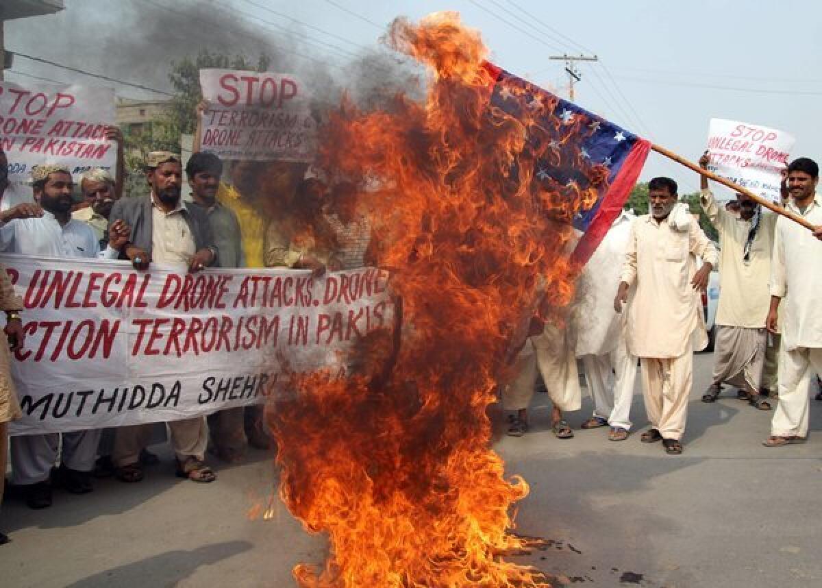 Pakistani protesters from United Citizen Action burn the U.S. flag during a demonstration in Multan on Thursday against drone attacks in Pakistani tribal areas.