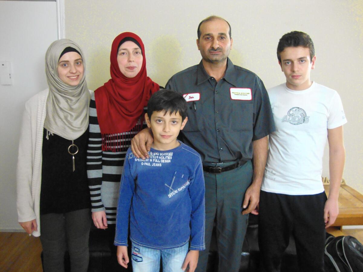 Syrian refugees Lina and husband Zein, with their children, from left, Hanadi, 18, Majd, 10, and Muhannad, 14, arrived in Houston last year. But their plans for stranded relatives to join them are now uncertain.