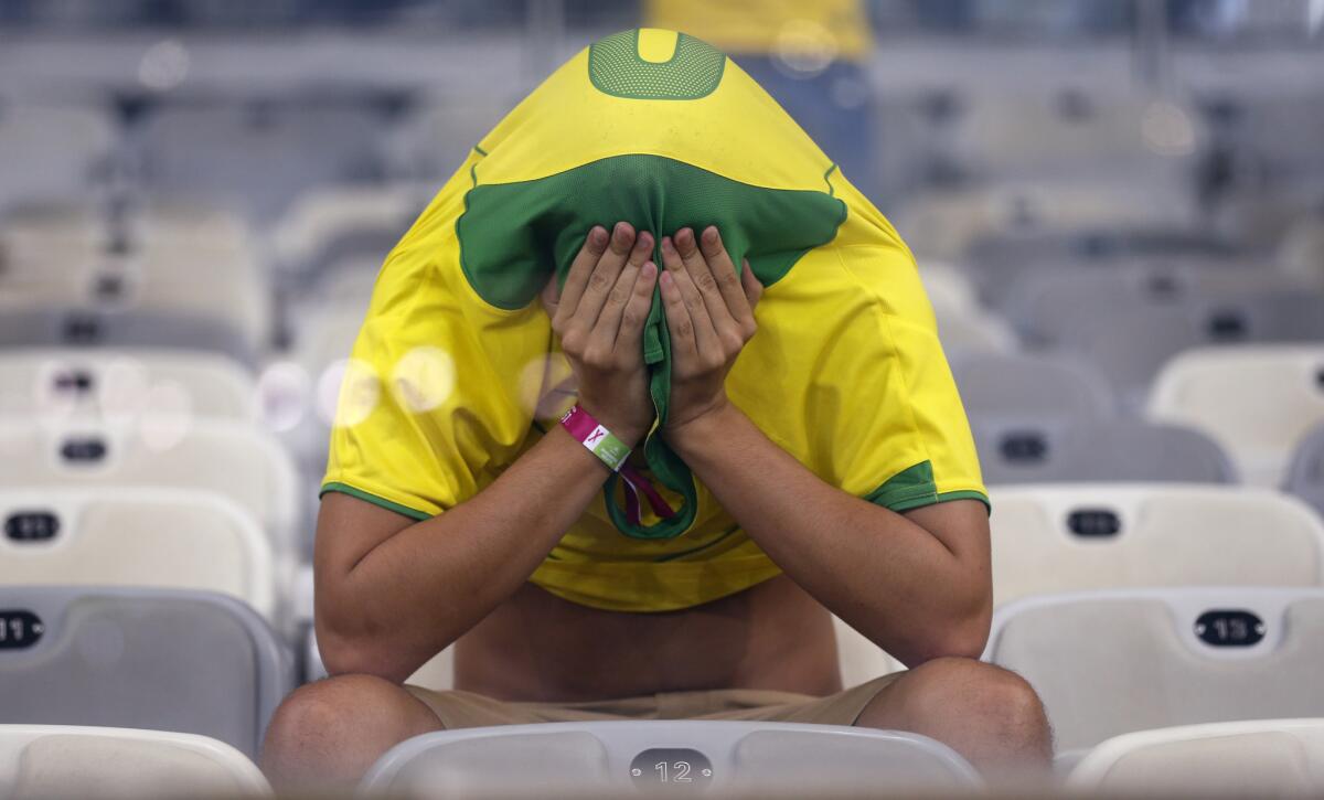 A Brazilian fan sits alone in the stands after Germany crushed Brazil, 7-1, in the World Cup semifinals in 2014.