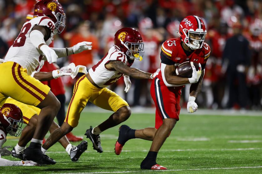 Maryland running back Nolan Ray (25) runs the ball past Southern California cornerback.