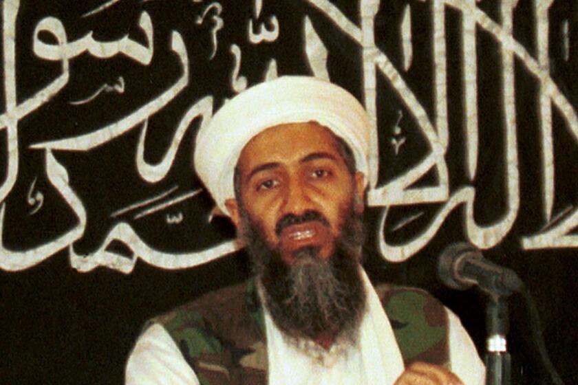 FILE - In this 1998 file photo made available on March 19, 2004, Osama bin Laden is seen at a news conference in Khost, Afghanistan. The CIA's release of documents seized during the 2011 raid that killed al-Qaida leader Osama bin Laden has again raised questions about Iran's support of the extremist network leading up to the Sept. 11 terror attacks. U.S. intelligence officials and prosecutors have long said Iran formed loose ties to the terror organization from 1991 on, something noted in a 19-page report in Arabic included in the release of some 47,000 other documents by the CIA. Iran always has denied any links. (AP Photo/Mazhar Ali Khan, File)