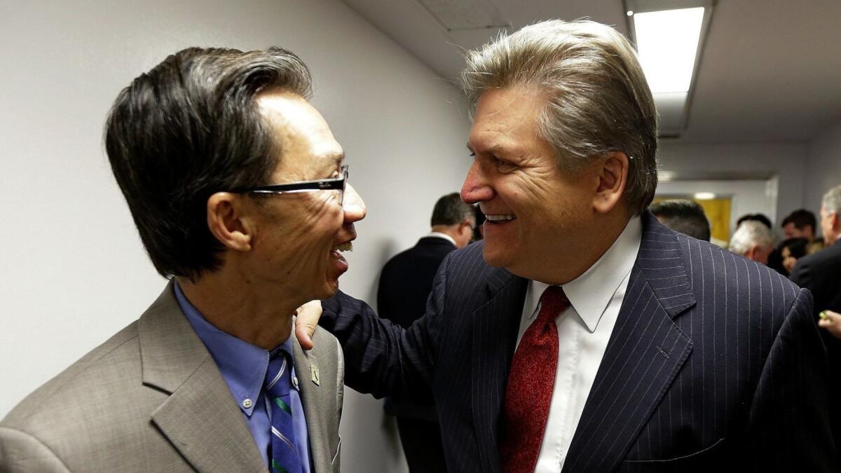 Assemblyman Ed Chau (D-Arcadia), left, and Sen. Bob Hertzberg (D-Van Nuys) celebrate after their internet privacy bill was approved by the Senate Judiciary Committee, in June 2018. Can they resist a business campaign to water it down?