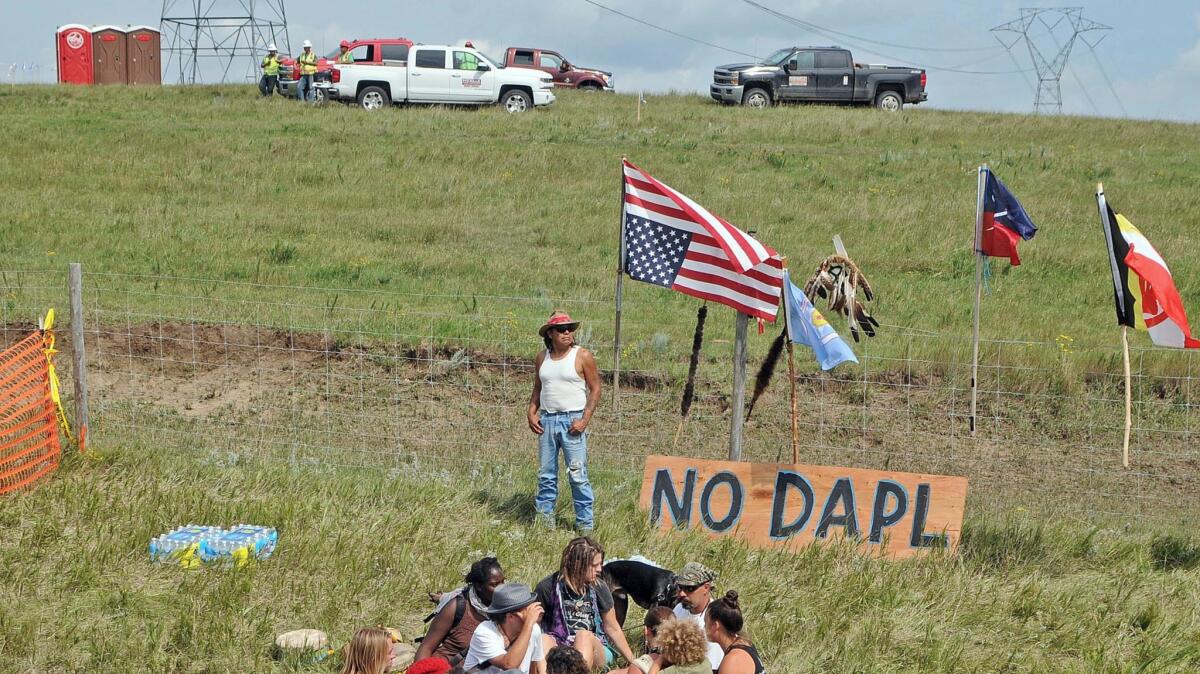 Bill Left Hand, of McLaughlin, South Dakota, stands next to a sign at the site of an Aug. 12 protest against construction of the Dakota Access Pipeline.