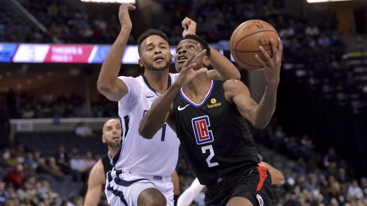 Clippers guard Shai Gilgeous-Alexander (2) drives against Memphis Grizzlies forward Kyle Anderson (1) in the first half on Wednesday.