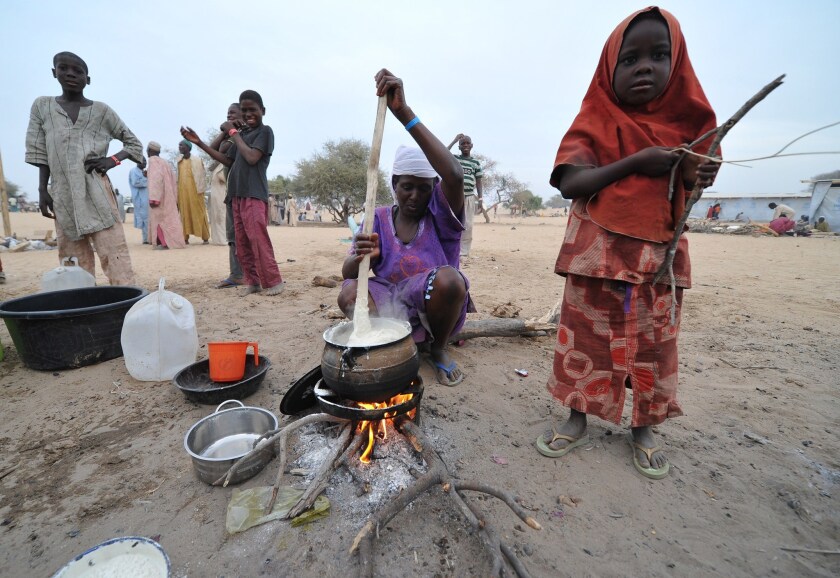 Nigerian refugees prepare food Jan. 29 at a refugee camp run by the United Nations in Baga Sola, Chad. They arrived in the camp after an attack this month by Boko Haram militants in the Nigerian town of Baga.