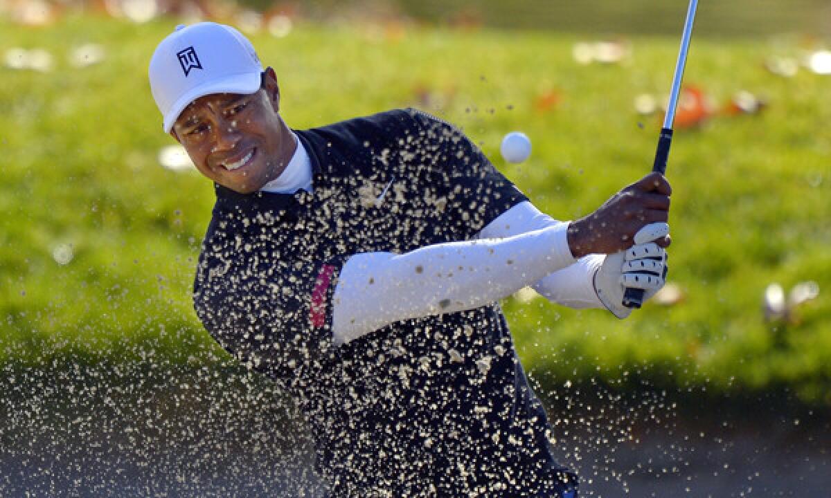Tiger Woods hits out of a bunker on the second hole during the third round of the Northwestern Mutual World Challenge at Sherwood Country Club in Thousand Oaks on Saturday.