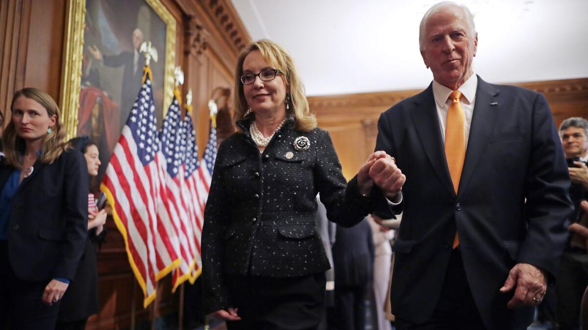Former Congresswoman Gabby Giffords, who was shot in Tucson in 2011, joins Rep. Mike Thompson at a Feb. 19 news conference at the Capitol to introduce legislation to expand background checks for firearm sales.