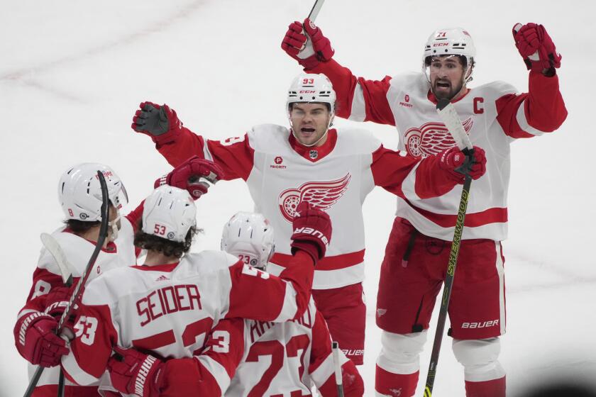 Detroit Red Wings' Moritz Seider (53) celebrates with teammates after his goal against the Montreal Canadiens during the first period of an NHL hockey game Tuesday, April 16, 2024, in Montreal. (Christinne Muschi/The Canadian Press via AP)