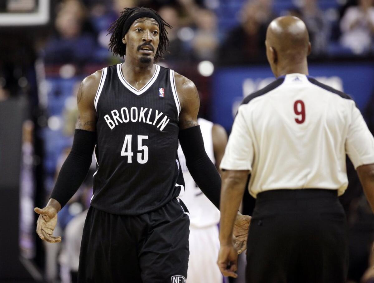Brooklyn Nets forward Gerald Wallace, left, spars with official Derrick Stafford on Sunday in a game against the Sacramento Kings. The Nets won 99-90 and now face the Lakers tonight.