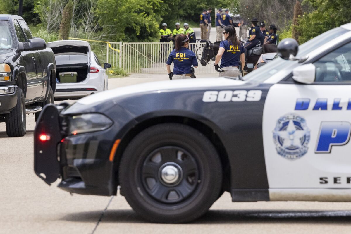 Dallas Police and members of the FBI investigate the scene close to where a toddler was found dead with multiple wounds on Saturday, May 15, 2021, in the Mountain Creek area of Dallas. (Juan Figueroa/The Dallas Morning News via AP)