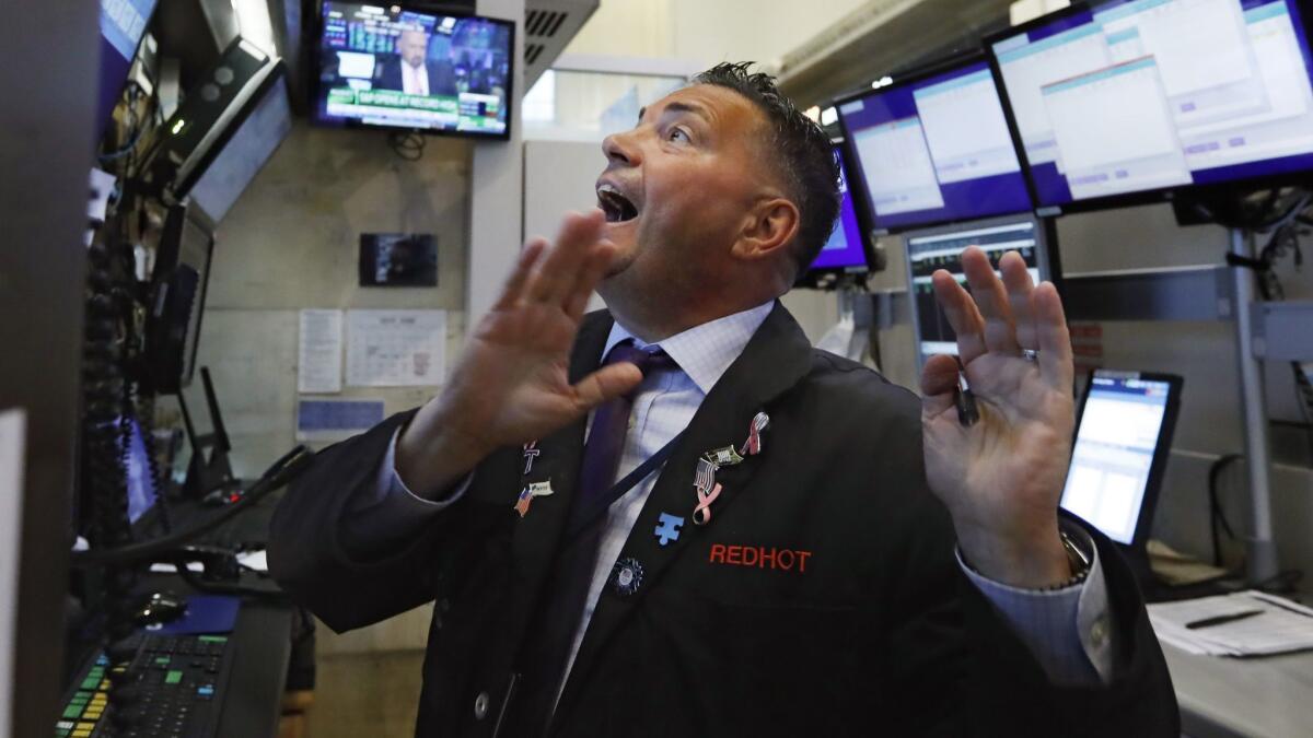 Trader Jonathan Muller works in his booth on the floor of the New York Stock Exchange on Monday.