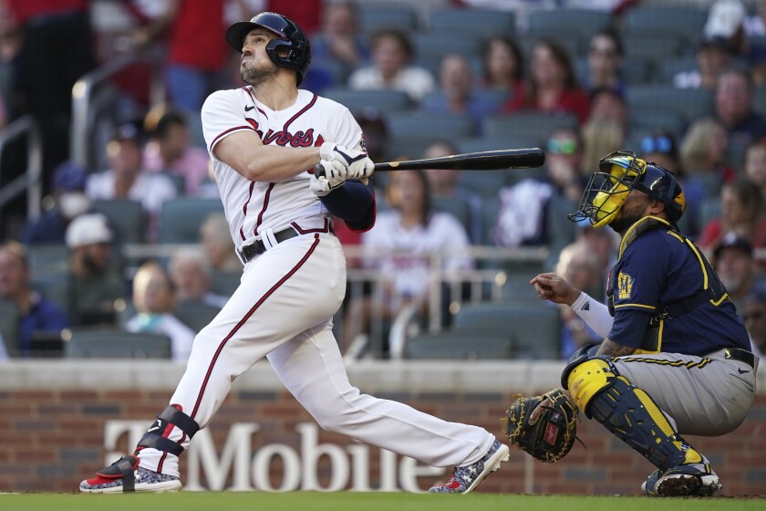 Atlanta Braves' Adam Duvall hits a single against the Milwaukee Brewers during Game 4