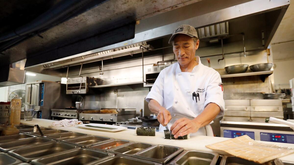 Chef Steven Kwok prepares a Spam sushi roll at Don the Beachcomber in Huntington Beach. He has been the head chef there for six years.