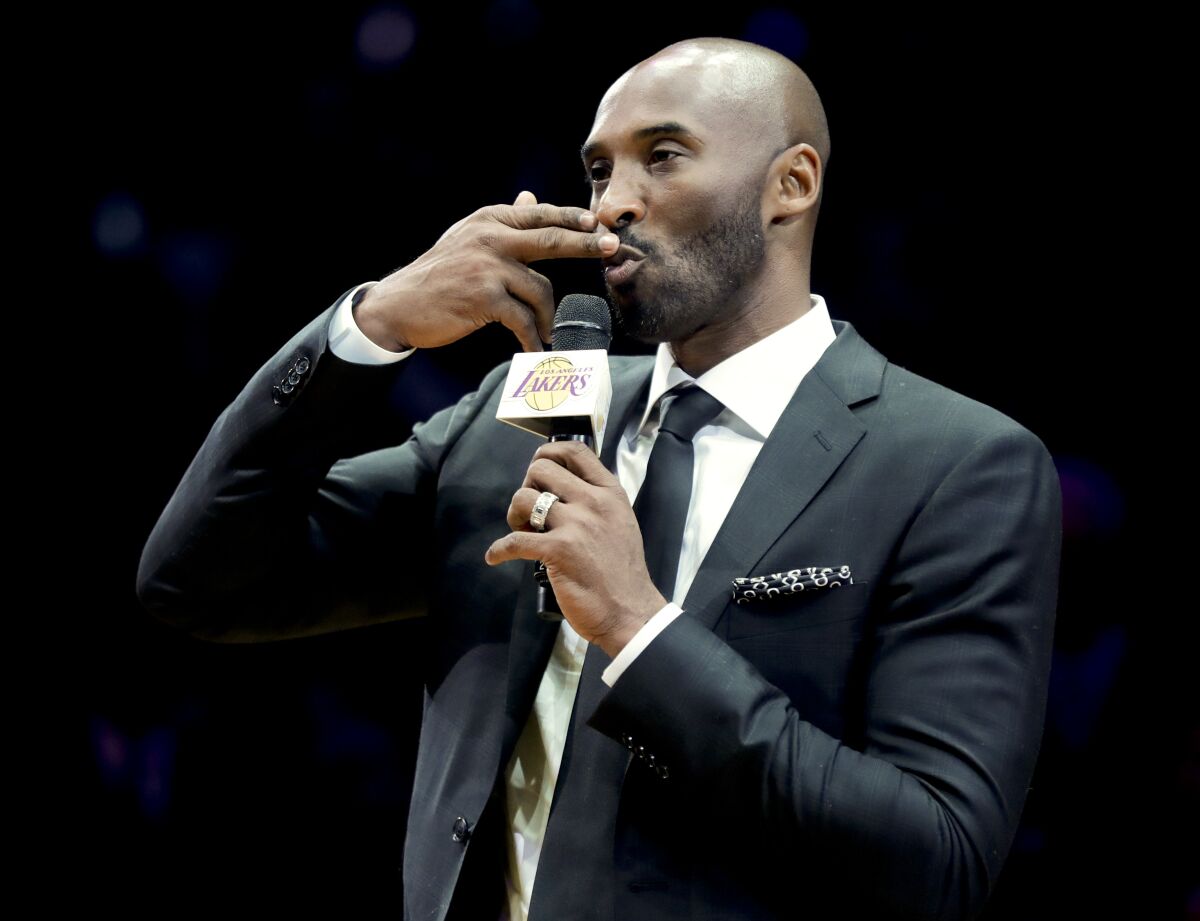 Kobe Bryant speaks during a halftime ceremony to retire both of his Lakers jerseys, Nos. 8 and 24, at Staples Center.