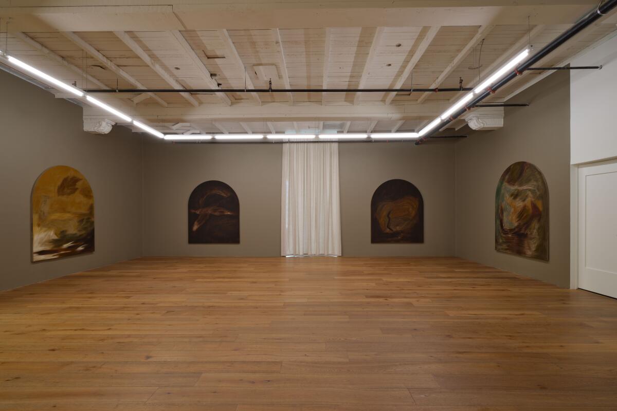 Large paintings on a gray gallery wall