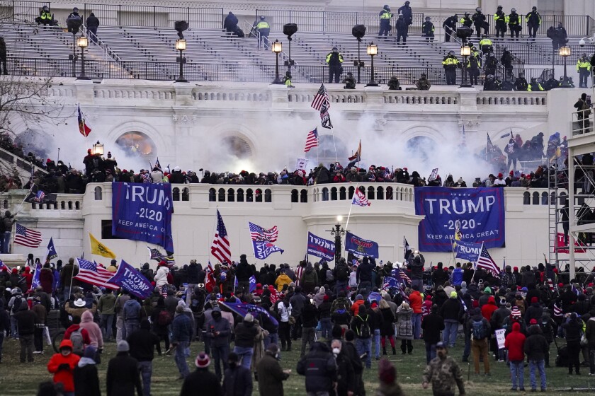 FILE - In this Jan. 6, 2021, file photo, violent protesters, loyal to President Donald Trump, storm the Capitol in Washington. Seattle Police Chief Adrian Diaz on Friday, Aug. 6, 2021, fired the two Seattle police officers who violated the law while attending events in Washington D.C. during the Jan. 6 insurrection. Diaz said he fired Caitlin and Alexander Everett, the two officers who are married, effective immediately. (AP Photo/John Minchillo, File)