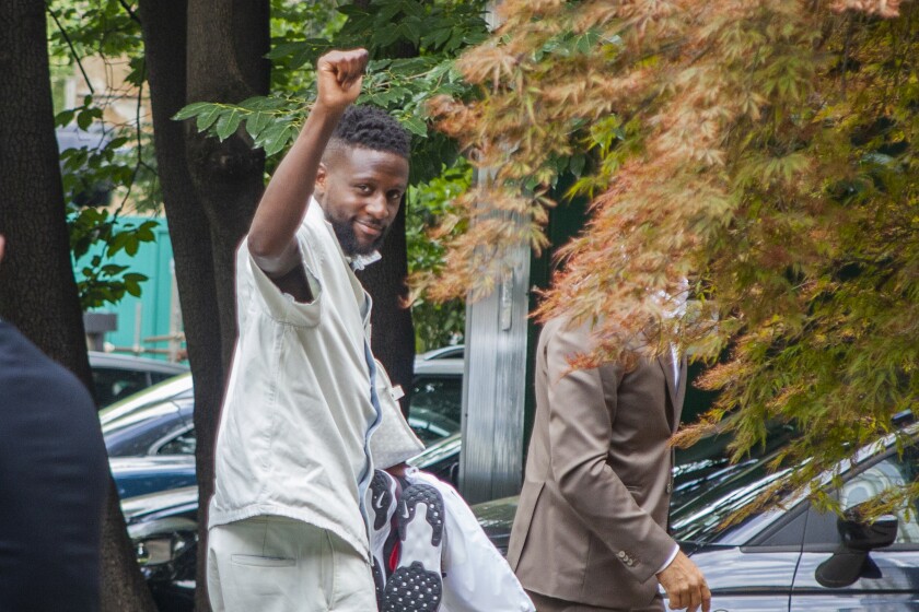 Belgium's Divock Origi salutes fans as he arrives to undergo his medical examinations ahead of moving to AC Milan on a free transfer from Liverpool, in Milan, Italy, Tuesday, June 28, 2022. (LaPresse via AP)