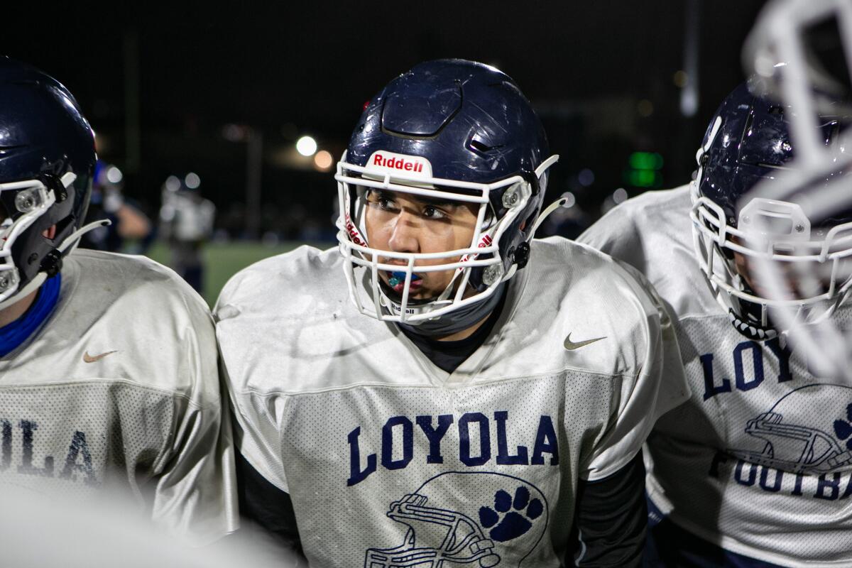 Football player Josh Morales on field with his teammates