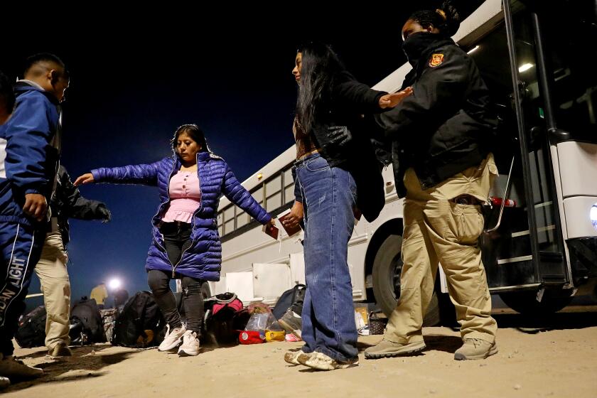 SOMERTON, AZ - MAY 12: Migrants turn themselves over to U.S Border Patrol agents along the U.S.-Mexico border on Friday, May 12, 2023 in Somerton, AZ. Title 42, a pandemic-era policy that allowed border agents to quickly turn back migrants, expires this week. Under a new rule, the U.S. on Thursday will begin denying asylum to migrants who show up at the U.S.-Mexico border without first applying online or seeking protection in a country they passed through. (Gary Coronado / Los Angeles Times)