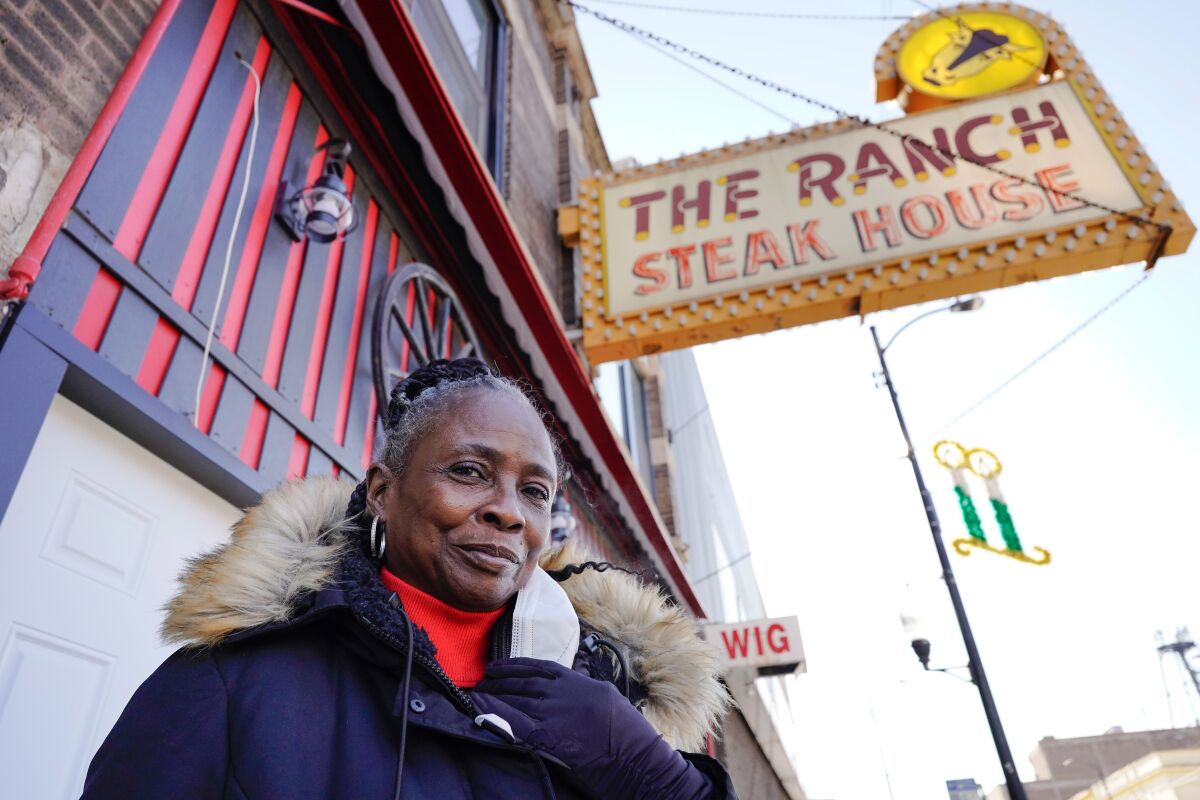 Woman beneath restaurant sign