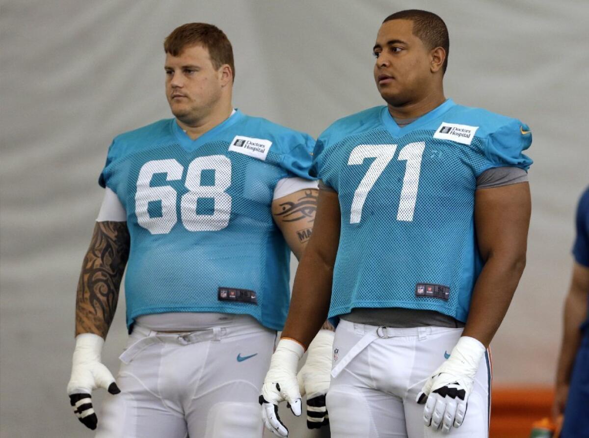 Miami Dolphins guard Richie Incognito (68) and tackle Jonathan Martin (71) during practice in July.