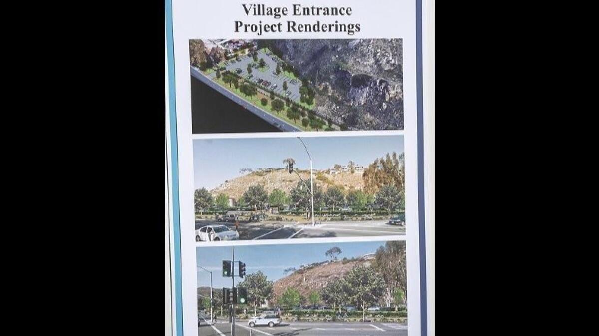 Village Entrance renderings are displayed at the project's groundbreaking ceremony Tuesday.