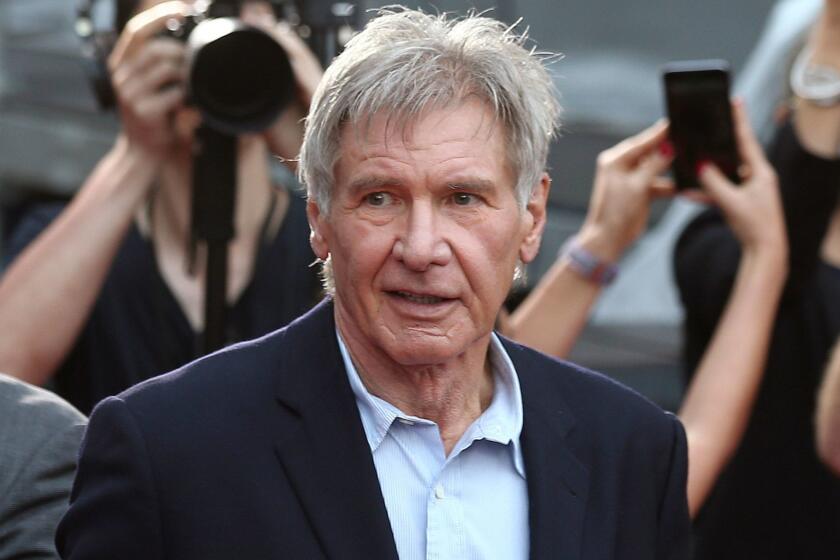 FILE - In this December 10, 2015 file photo, Harrison Ford greets fans during a Star Wars fan event in Sydney, Australia. Ford told an air traffic controller he was distracted and concerned about turbulence from another aircraft when he mistakenly landed his small plane on a taxiway at a Southern California airport in Feb. 2017. (AP Photo/Rob Griffith, File)
