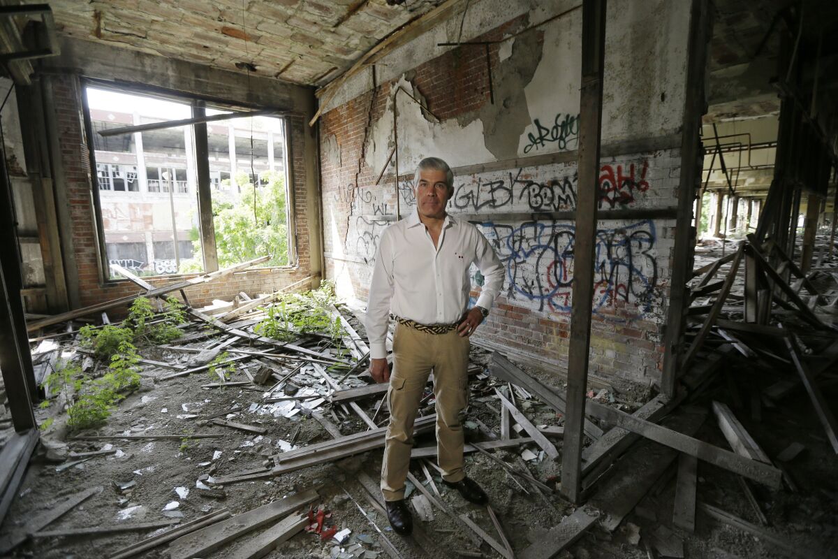 FILE- In this June 27, 2014, photo, Packard Plant owner Fernando Palazuelo stands in his proposed future office at the industrial site in Detroit. A judge has deemed the deteriorating Packard plant on Detroit's east side a public nuisance and ordered its Peruvian owner to tear the former auto factory down. Wayne County Circuit Court Judge Brian Sullivan wrote in a March 31, 2022, order that Palazuelo and his Arte Express Detroit must remove all rubbish and debris from the sprawling site that covers several city blocks and demolish all buildings and structures on the property. (AP Photo/Carlos Osorio, File)