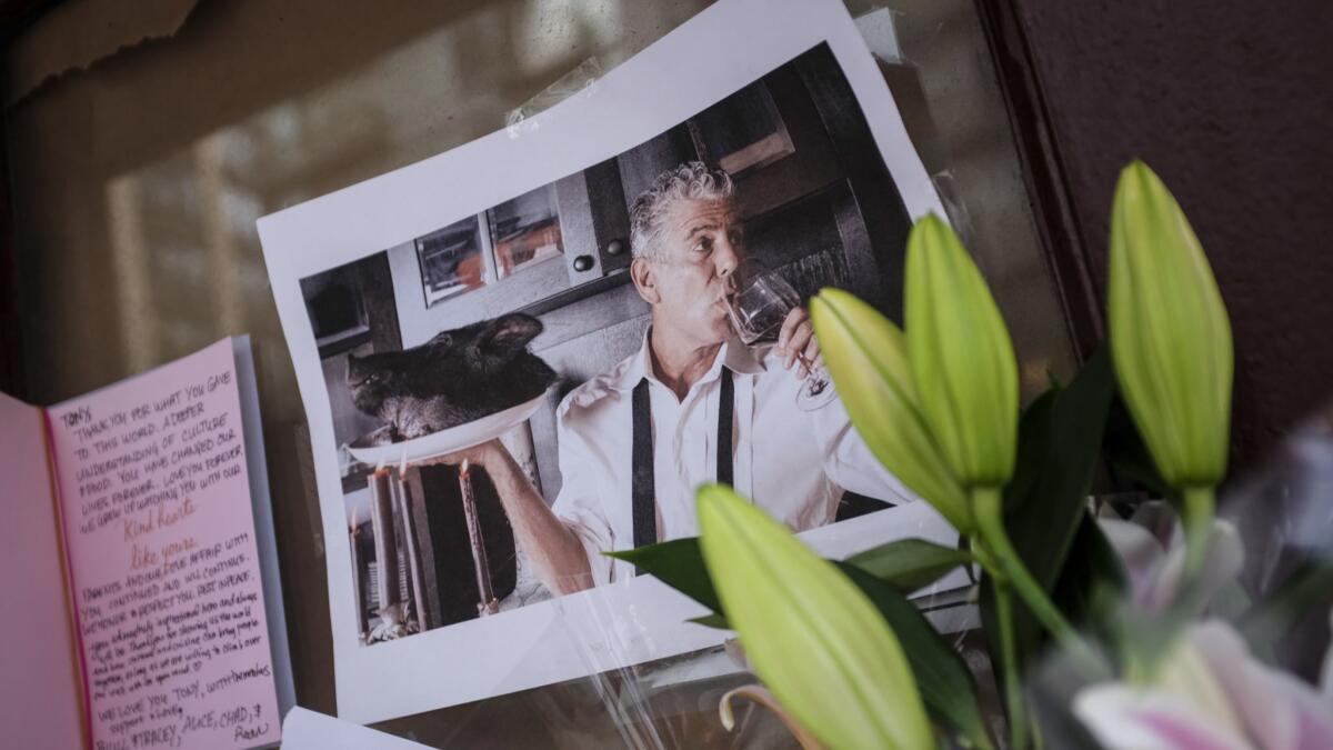 Notes and photographs are left in memory of Anthony Bourdain at the closed location of New York's Brasserie Les Halles, where he was the executive chef.