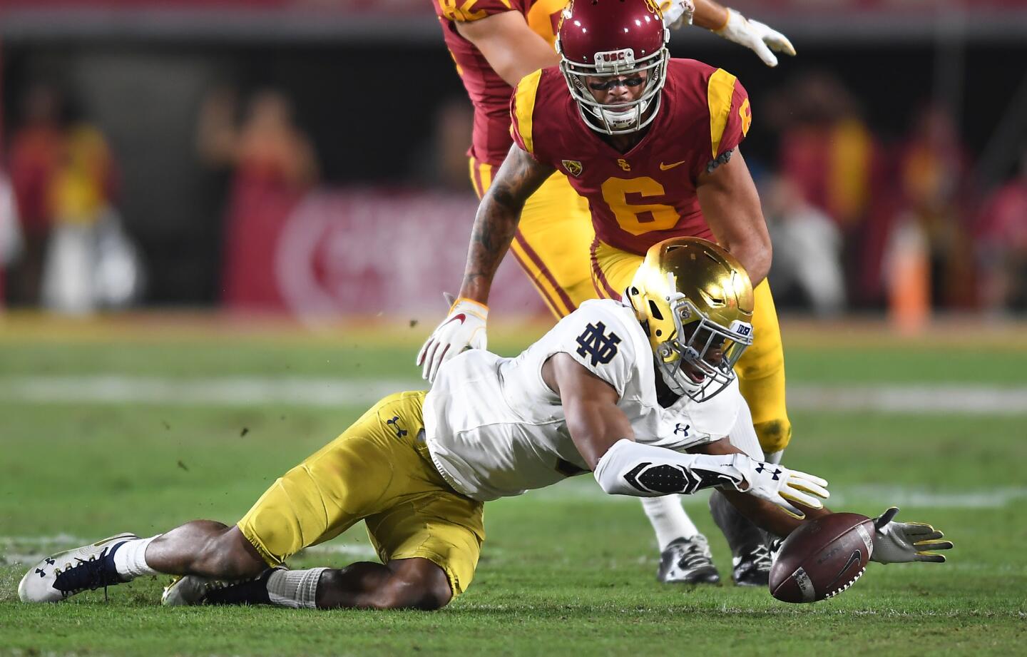Notre Dame's Troy Price recovers a fumble by USC receiver Michael Pittman in the first quarter at the Coliseum.