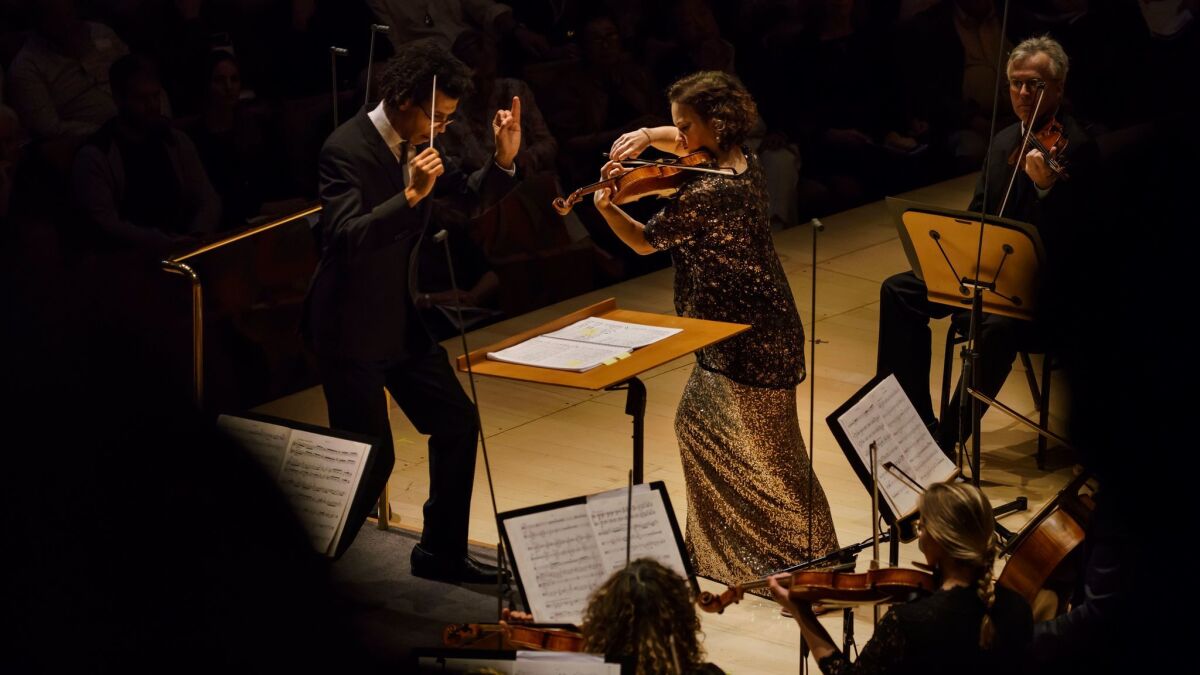 Conductor Jonathon Heyward and violin soloist Hilary Hahn perform "Serenade" by composer Leonard Bernstein, with the Los Angeles Philharmonic on Sunday at Disney Hall.