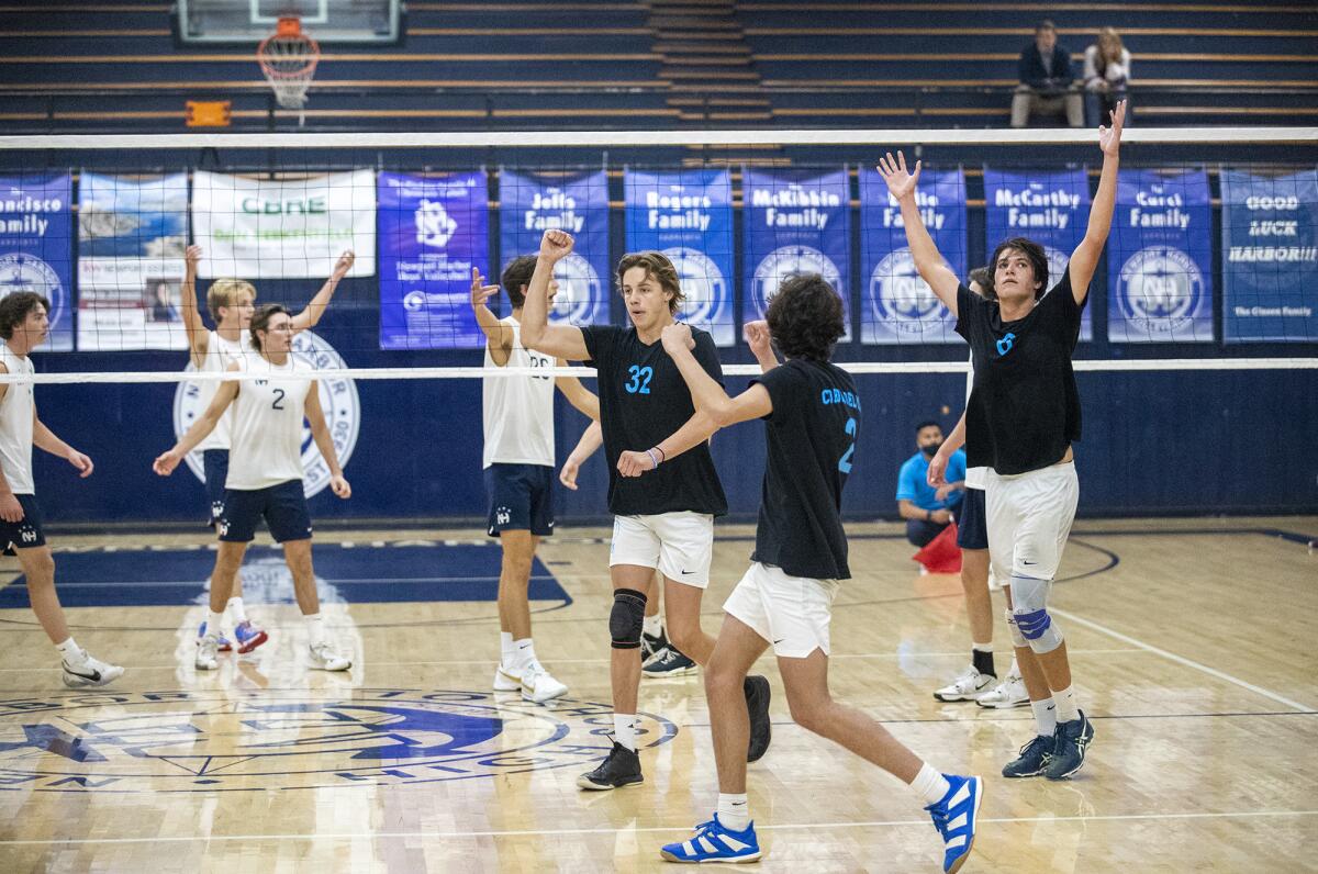 Corona del Mar celebrates winning a point against Newport Harbor during a Surf League boys' volleyball match on Tuesday.