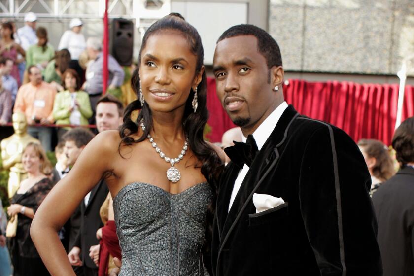 Kim Porter and Sean 'Diddy' Combs pose together in formalwear on the Oscars red carpet