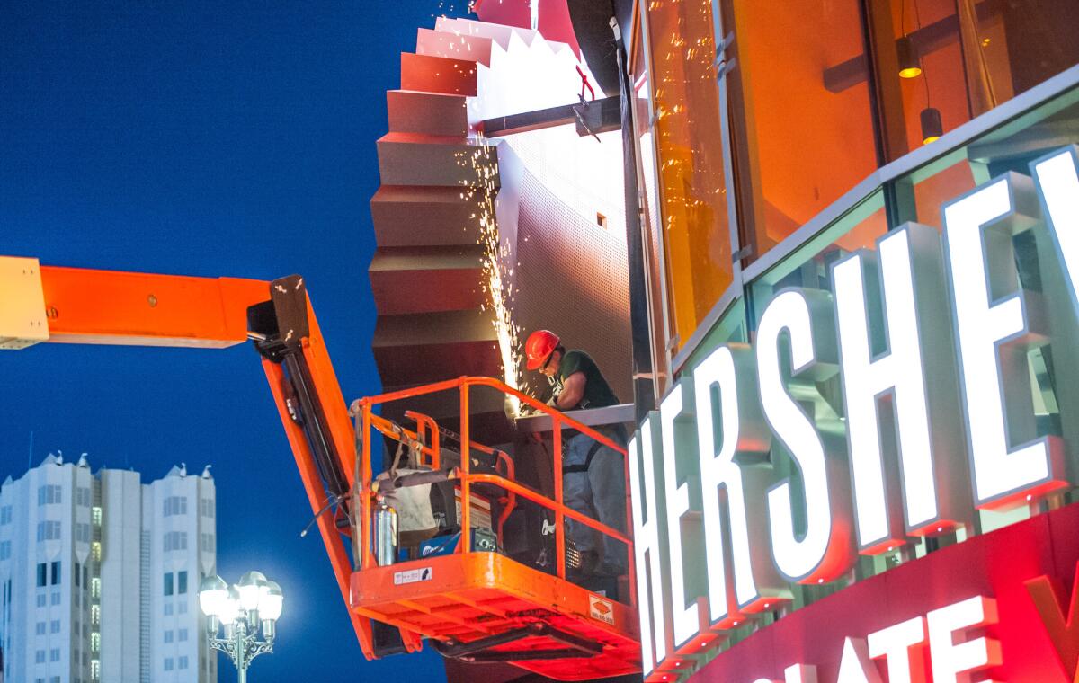 An 18-foot Reese's Peanut Butter Cup is installed at the new Hershey's Chocolate World at New York-New York Hotel & Casino on the Las Vegas Strip.