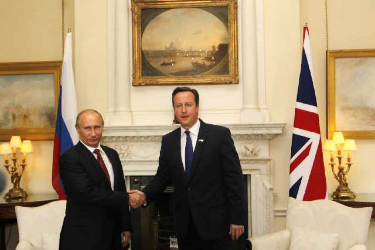 Russian President Vladimir Putin, left, and British Prime Minister David Cameron meet up before the judo match.
