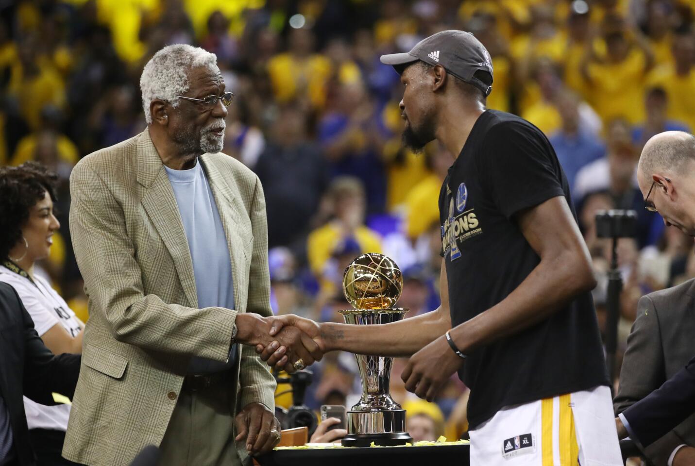 OAKLAND, CA - JUNE 12: Kevin Durant #35 of the Golden State Warriors is presented the Bill Russell NBA Finals Most Valuable Player Trophy by NBA Hall of Famer Bill Russell after defeating the Cleveland Cavaliers 129-120 in Game 5 to win the 2017 NBA Finals at ORACLE Arena on June 12, 2017 in Oakland, California. NOTE TO USER: User expressly acknowledges and agrees that, by downloading and or using this photograph, User is consenting to the terms and conditions of the Getty Images License Agreement. (Photo by Ezra Shaw/Getty Images) ** OUTS - ELSENT, FPG, CM - OUTS * NM, PH, VA if sourced by CT, LA or MoD **
