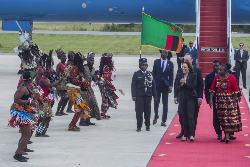 U.S. Vice President Kamala Harris, second right, is greeted by traditional dancers after landing in Lusaka, Zambia, Friday March 31, 2023. Harris is on the last leg of a a seven-day African visit that took her to Ghana and Tanzania. (AP Photo/Salim Dawood)