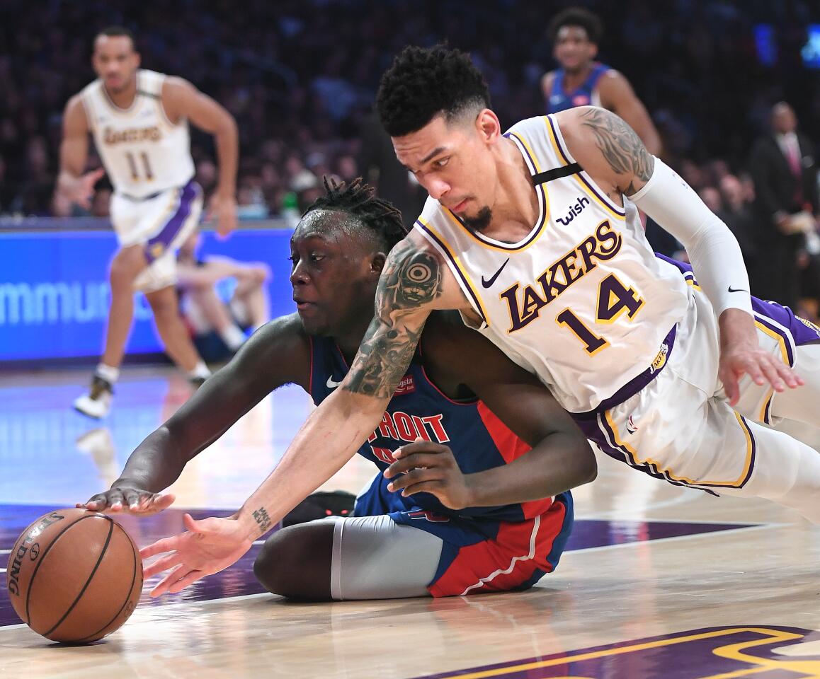 Lakers guard Danny Green and Detroit Pistons forward Sekou Doumbouya battle for a loose ball during the second quarter.